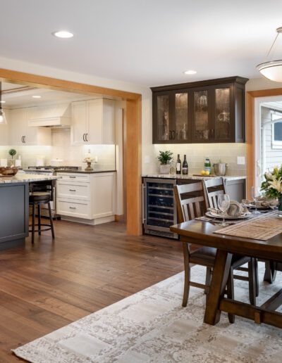 A kitchen with hardwood floors and a dining area.
