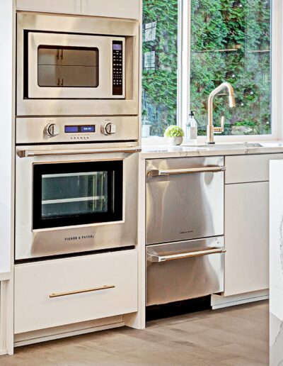 A white kitchen with stainless steel appliances.