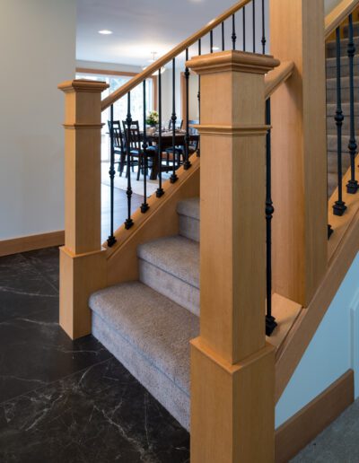 A staircase in a house with black railings.