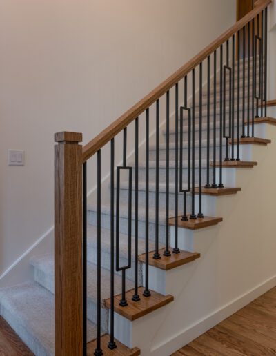 A stair railing in a home with hardwood floors.