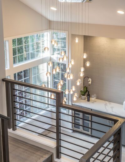 A modern home with a staircase and light fixtures.