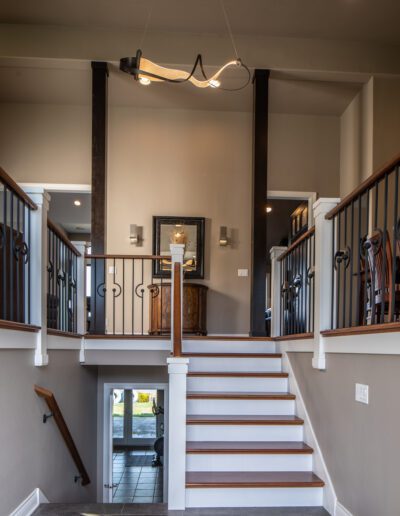 A staircase leading into a home with a light fixture.