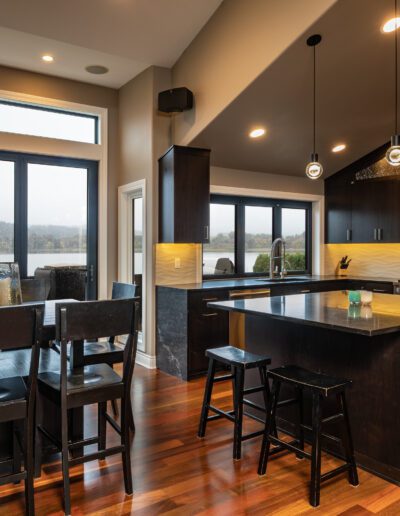 A kitchen with hardwood floors and a view of the lake.