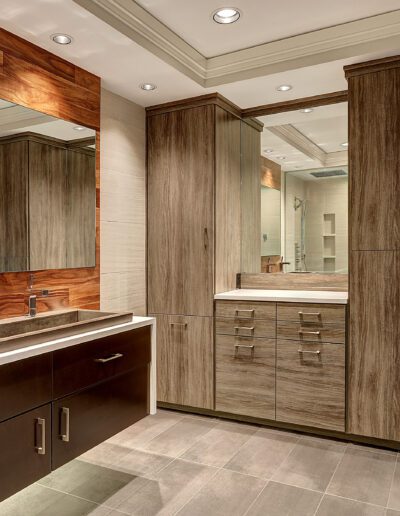 A bathroom with wooden cabinets and a sink.