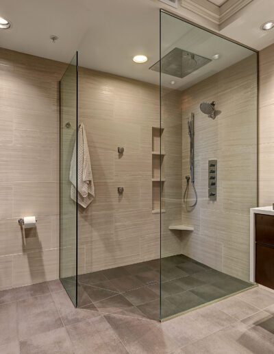 A bathroom with a glass shower stall and sink.
