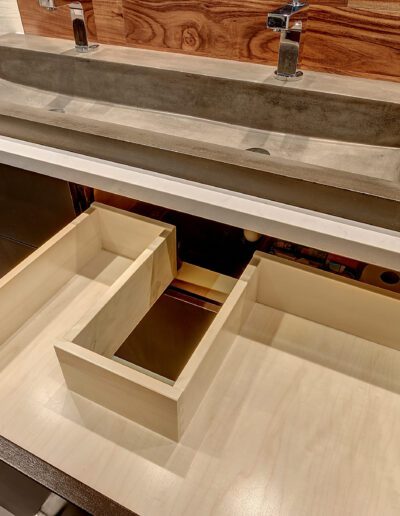A bathroom with a sink and a drawer under it.