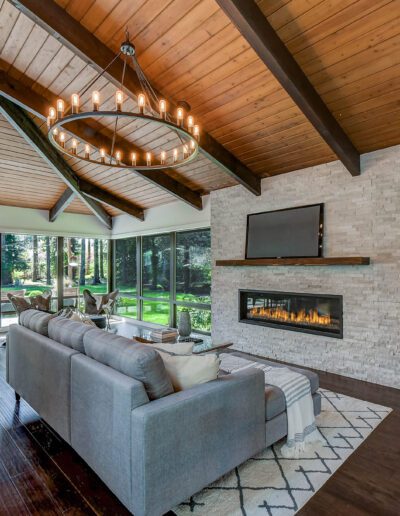 A modern living room with wood ceilings and a fireplace.