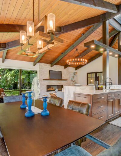 An open kitchen and dining room with wood ceilings.