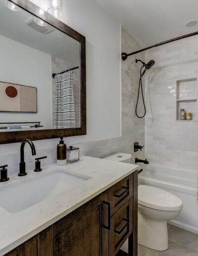 A bathroom with a sink, toilet and shower.