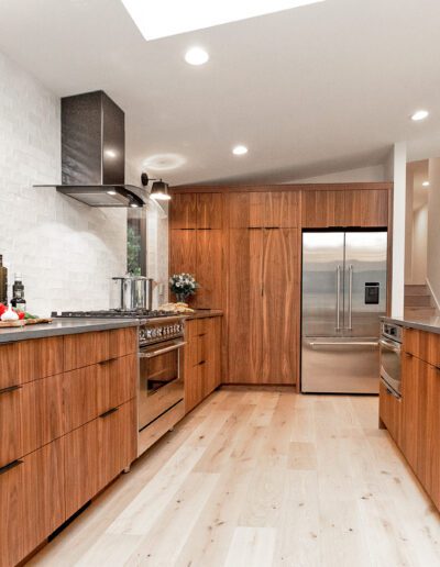 A modern kitchen with wood cabinets and stainless steel appliances.