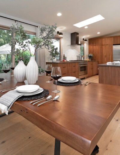 A kitchen with a wooden table and chairs.